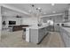 Open kitchen layout with a large island, barstool seating, and seamless flow into the living room at 136 Mosso Niente Pl, Henderson, NV 89011