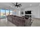 Contemporary living room with large sliding glass doors, stylish furniture, and entertainment center at 136 Mosso Niente Pl, Henderson, NV 89011