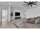 Bright and airy living room with a large TV, modern decor, and stylish tile flooring at 136 Mosso Niente Pl, Henderson, NV 89011