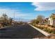 Neighborhood street view featuring well-maintained landscaping and a speed limit sign at 136 Mosso Niente Pl, Henderson, NV 89011