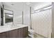 Modern bathroom featuring a sleek vanity, tiled walls, walk-in shower, and lots of natural light at 1786 Diamond Rim Ct, Henderson, NV 89012