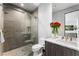 Bathroom features a glass enclosed shower, toilet and single sink vanity with red flowers at 1786 Diamond Rim Ct, Henderson, NV 89012