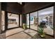 Inviting entryway reveals a stylish home office with a large glass wall and decorative landscaping at 1786 Diamond Rim Ct, Henderson, NV 89012