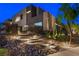 Modern two-story home featuring an elegant rock garden and well lit pathway leading to the front door at 1786 Diamond Rim Ct, Henderson, NV 89012