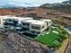 Modern two-story home with a pool, an outdoor seating area, and landscaped yard with mountain views at 1786 Diamond Rim Ct, Henderson, NV 89012