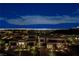 Night view of modern homes with city lights in the background, showcasing elegant architecture at 1786 Diamond Rim Ct, Henderson, NV 89012