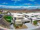 Daytime aerial view of modern homes surrounded by desert landscape, with city skyline in the distance at 1786 Diamond Rim Ct, Henderson, NV 89012