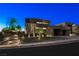 Modern home exterior with landscaped front yard and illuminated walkway leading to the entrance at 1786 Diamond Rim Ct, Henderson, NV 89012