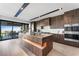 Modern kitchen features stainless appliances, a large island with bar seating, and sliding glass doors to outdoor living at 1786 Diamond Rim Ct, Henderson, NV 89012