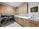 Well-organized laundry room with sleek cabinets and modern washer/dryer at 1786 Diamond Rim Ct, Henderson, NV 89012