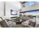 Open-concept living room featuring a modern fireplace, sectional sofa, and a wall of windows at 1786 Diamond Rim Ct, Henderson, NV 89012