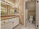 Bathroom featuring granite counters, double vanity, and a mirrored medicine cabinet above a sink at 1851 Hillpointe Rd # 2124, Henderson, NV 89074