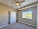 Neutral bedroom with plush carpeting, ceiling fan, sliding closet, and view to outside at 1851 Hillpointe Rd # 2124, Henderson, NV 89074