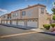 Exterior view of home showing garages and upper floor with balconies on a sunny day at 1851 Hillpointe Rd # 2124, Henderson, NV 89074