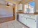 Kitchen featuring white cabinets, stainless steel dishwasher and large window at 1851 Hillpointe Rd # 2124, Henderson, NV 89074