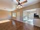 Bright living room area flowing into kitchen featuring wood flooring and natural light at 1851 Hillpointe Rd # 2124, Henderson, NV 89074