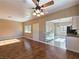 Bright, open-concept living room with hardwood floors, ceiling fan, and seamless flow into the modern kitchen at 1851 Hillpointe Rd # 2124, Henderson, NV 89074