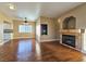 Bright living room with hardwood floors, fireplace, ceiling fan, and an open view into the connected kitchen at 1851 Hillpointe Rd # 2124, Henderson, NV 89074
