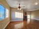 Inviting living room featuring a ceiling fan, hardwood floors, natural light, and a classic fireplace at 1851 Hillpointe Rd # 2124, Henderson, NV 89074