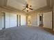 Expansive primary bedroom with plush carpeting, a ceiling fan, and generous closet space for ample storage at 1851 Hillpointe Rd # 2124, Henderson, NV 89074