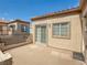 View of a private patio with sliding glass doors to the home's interior and a stucco wall at 1851 Hillpointe Rd # 2124, Henderson, NV 89074