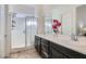 Modern bathroom boasts double sinks, large mirror, and a glass-enclosed shower at 216 Copland Canyon Ave, Henderson, NV 89011