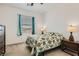 Cozy bedroom featuring a floral bedspread, side tables and a large window at 216 Copland Canyon Ave, Henderson, NV 89011