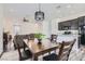 Open dining area featuring a wood table with chairs and a modern chandelier at 216 Copland Canyon Ave, Henderson, NV 89011