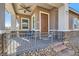 Inviting front porch featuring a cozy seating area and decorative brick accents at 216 Copland Canyon Ave, Henderson, NV 89011