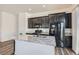 Modern kitchen featuring dark cabinetry and stainless steel appliances at 216 Copland Canyon Ave, Henderson, NV 89011