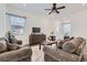 Cozy living room with neutral tones, comfortable sofas, and a ceiling fan at 216 Copland Canyon Ave, Henderson, NV 89011