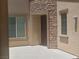 Welcoming front entrance with stone accents and neutral stucco walls, offering a cozy and inviting curb appeal at 2188 Anserville Ave, Henderson, NV 89044