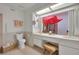 The bathroom features double sinks and a view to an atrium with a red umbrella at 2541 La Cara Ave, Las Vegas, NV 89121