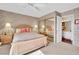 Cozy bedroom with patterned wallpaper, mirrored closet, and ensuite bathroom access at 2541 La Cara Ave, Las Vegas, NV 89121