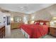 A cozy bedroom features a red bedspread and a dresser with decorative wallpaper at 2541 La Cara Ave, Las Vegas, NV 89121