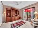 Comfortable living room with custom built-ins, a red area rug, and a slider to an outdoor space at 2541 La Cara Ave, Las Vegas, NV 89121