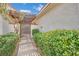 Gated walkway lined with hedges and a covered trellis at 2541 La Cara Ave, Las Vegas, NV 89121