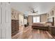 Bedroom with wood-look flooring, ceiling fan, dresser and adjoining bathroom at 2737 Sunrise Day Ct, Las Vegas, NV 89142