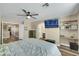 Bedroom with wood-look flooring, ceiling fan, dresser, shelves and tv at 2737 Sunrise Day Ct, Las Vegas, NV 89142