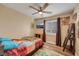 Bedroom with natural light, a TV, a ceiling fan, and hardwood floors at 2737 Sunrise Day Ct, Las Vegas, NV 89142