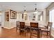 Charming dining area with a rustic wooden table, modern pendant lights, and elegant decor, creating an inviting space at 2737 Sunrise Day Ct, Las Vegas, NV 89142