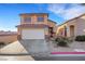 Charming two-story home with a driveway and desert-style landscaping in front yard at 2737 Sunrise Day Ct, Las Vegas, NV 89142