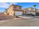 Attractive home featuring a two-car garage, desert landscaping, and a tiled roof at 2737 Sunrise Day Ct, Las Vegas, NV 89142