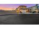 Street view of a two-story home with a two-car garage and a simple, low-maintenance yard at 2737 Sunrise Day Ct, Las Vegas, NV 89142