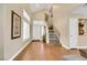 Bright foyer featuring hardwood floors, a staircase, and elegant decor at 2737 Sunrise Day Ct, Las Vegas, NV 89142