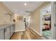 Hallway featuring wood-look flooring, built in cabinets and entry to bedroom with ceiling fan at 2737 Sunrise Day Ct, Las Vegas, NV 89142