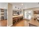 Open kitchen featuring breakfast bar with seating, stylish pendant lights, and gray cabinetry at 2737 Sunrise Day Ct, Las Vegas, NV 89142