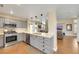 Open kitchen featuring stainless steel appliances, gray cabinets, and view into the living room at 2737 Sunrise Day Ct, Las Vegas, NV 89142