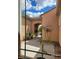 Through a window, a charming courtyard features a gate, desert landscaping and stucco walls at 2764 Leys Burnett Ave, Henderson, NV 89044