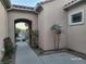 Inviting courtyard entryway with decorative gate, desert landscaping and stucco walls at 2764 Leys Burnett Ave, Henderson, NV 89044